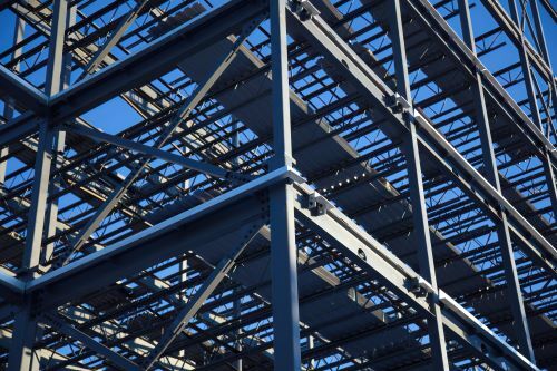 Structural steel beams against a blue sky